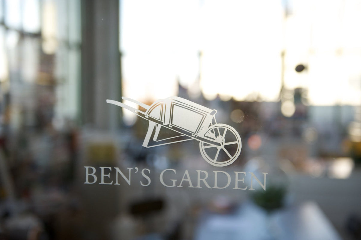 The Ben's Garden wheelbarrow etched on the studio glass