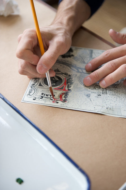 Hand-painting color onto an antique map of Paris