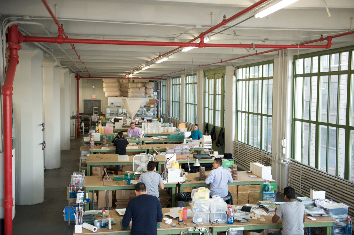Artisans at the long worktables of the Ben's Garden studio in Brooklyn